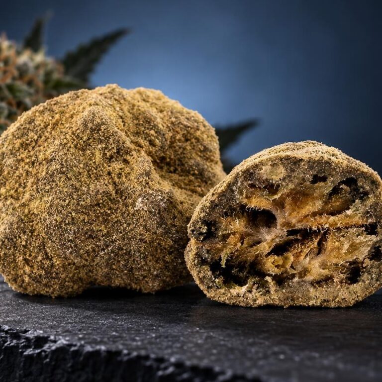 CBG effet : moon Rock CBN à texture granuleuse dorée, entier et tranché en deux, avec fleur de cannabis en arrière-plan