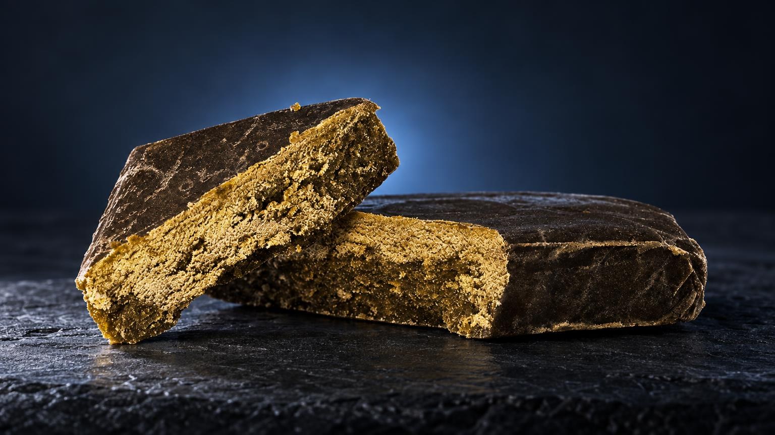 Three golden-brown solventless hash blocks with textured surfaces on dark background, illustrating Static Hash product f
